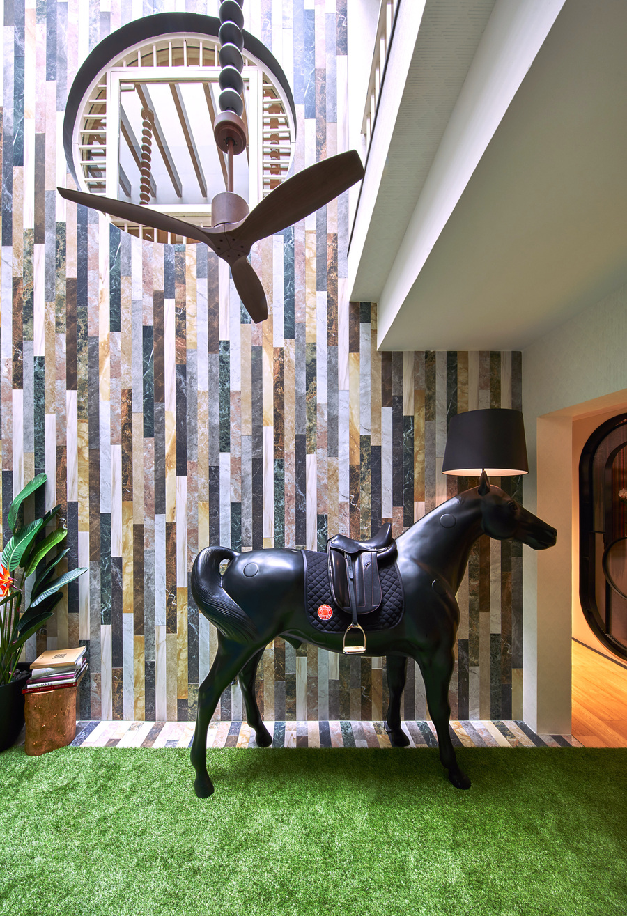 hallway with a horse statue and floor lamp